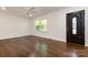 Bright living room with hardwood floors, large windows, and a stylish front door at 2528 Arnold Dr, Charlotte, NC 28205