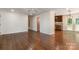 Open-concept living room featuring hardwood floors, crown molding, and neutral walls at 2528 Arnold Dr, Charlotte, NC 28205