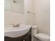 Updated half bath boasts a modern vanity, sink, and toilet, creating a fresh and inviting space at 2528 Arnold Dr, Charlotte, NC 28205