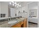 Bathroom featuring a double sink vanity with granite countertop and decor at 2638 Dilworth Heights Ln, Charlotte, NC 28209