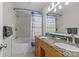 Bathroom features a double sink vanity, a bathtub, and a shower at 2638 Dilworth Heights Ln, Charlotte, NC 28209
