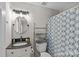 Bathroom featuring a vanity sink, a round mirror, and a bathtub shower at 2638 Dilworth Heights Ln, Charlotte, NC 28209
