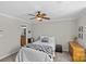 Cozy bedroom with a view to the ensuite bathroom, a dresser, and ceiling fan at 2638 Dilworth Heights Ln, Charlotte, NC 28209