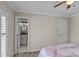 Bedroom with a view to the bathroom and a window with shutters at 2638 Dilworth Heights Ln, Charlotte, NC 28209