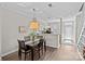Open dining area with hardwood floors and view of the kitchen and entry at 2638 Dilworth Heights Ln, Charlotte, NC 28209