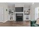 Living room with a fireplace, built-in bookshelves, and hardwood floors at 2638 Dilworth Heights Ln, Charlotte, NC 28209