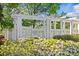 An in-ground swimming pool, partially visible behind lush landscaping at 2638 Dilworth Heights Ln, Charlotte, NC 28209