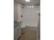 Bathroom featuring a shower-tub combo and ceramic tile flooring, plus granite vanity at 301 E 11Th St, Kannapolis, NC 28083