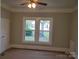 Bedroom with tan carpet and two large windows with natural light and painted trim at 301 E 11Th St, Kannapolis, NC 28083