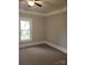 Bedroom with neutral carpet, trim, and paint, featuring a window at 301 E 11Th St, Kannapolis, NC 28083