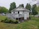 Exterior view with a new deck overlooking landscaped yard with mature trees at 301 E 11Th St, Kannapolis, NC 28083