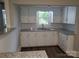 Cozy kitchen featuring white cabinetry, granite countertops, a stainless steel sink, and a window view at 301 E 11Th St, Kannapolis, NC 28083