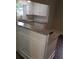 Updated kitchen with granite countertops, white cabinetry, and breakfast bar to the side at 301 E 11Th St, Kannapolis, NC 28083