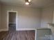 Open floor plan of living room and breakfast bar area with laminate flooring and neutral tones at 301 E 11Th St, Kannapolis, NC 28083