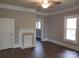 Open living room featuring freshly painted walls, an ornate fireplace, and laminate flooring at 301 E 11Th St, Kannapolis, NC 28083