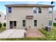 Spacious backyard with a concrete patio, offering a relaxing outdoor space for entertainment or quiet enjoyment at 305 Augustus Ln, Mount Holly, NC 28120