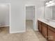 Bathroom featuring a modern vanity, updated fixtures, and an open doorway to the walk-in closet at 305 Augustus Ln, Mount Holly, NC 28120