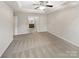 Spacious bedroom with plush carpet and tray ceiling, leading to bathroom and walk-in closet at 305 Augustus Ln, Mount Holly, NC 28120