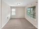Bedroom featuring neutral carpet, two windows, and ample space at 305 Augustus Ln, Mount Holly, NC 28120