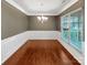 Traditional dining room featuring hardwood floors, elegant wainscoting, and a chandelier at 305 Augustus Ln, Mount Holly, NC 28120