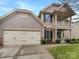 Charming two-story home featuring a two-car garage, inviting front porch and upper level balcony at 305 Augustus Ln, Mount Holly, NC 28120
