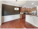 Charming kitchen view with hardwood floors, granite counters, and open to dining space at 305 Augustus Ln, Mount Holly, NC 28120