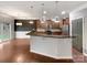 Open kitchen with a granite countertop island, stainless steel appliances, and hardwood floors at 305 Augustus Ln, Mount Holly, NC 28120
