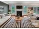 Bright living room with a cozy fireplace, stylish furniture, and seamless access to the outdoor area at 305 Augustus Ln, Mount Holly, NC 28120