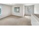 Well-lit living room space with plush carpet, perfect for relaxing at 305 Augustus Ln, Mount Holly, NC 28120