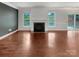 Clean, spacious living room with a fireplace and hardwood floors, offering a blank canvas for customization at 305 Augustus Ln, Mount Holly, NC 28120