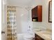 Bright bathroom featuring a shower with decorative curtain, toilet, and vanity with storage at 308 Greenwood Pl, Belmont, NC 28012