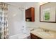 Bright bathroom featuring a shower with decorative curtain, toilet, and vanity with storage at 308 Greenwood Pl, Belmont, NC 28012