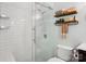 Bright bathroom featuring a glass-enclosed shower, floating shelves, and neutral decor at 308 Greenwood Pl, Belmont, NC 28012