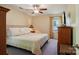 Comfortable bedroom with neutral tones, a ceiling fan, and a dresser with a TV at 308 Greenwood Pl, Belmont, NC 28012