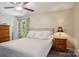 Bright bedroom featuring a large bed, side tables, and view from the window at 308 Greenwood Pl, Belmont, NC 28012