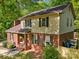 A charming two-story home with a brick facade, complemented by black shutters and a welcoming front porch at 308 Greenwood Pl, Belmont, NC 28012