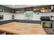 Bright kitchen with stainless steel appliances, butcher block island, and open shelving at 308 Greenwood Pl, Belmont, NC 28012