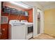 Functional laundry room with modern washer and dryer, storage shelves, and convenient access at 308 Greenwood Pl, Belmont, NC 28012