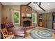 Comfortable living room with a brick fireplace, vaulted ceiling, hardwood floors, and leather seating at 308 Greenwood Pl, Belmont, NC 28012