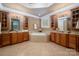 Bright bathroom featuring dual vanities, soaking tub, and decorative lighting fixtures at 3301 Mcpherson St, Waxhaw, NC 28173