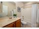 A well-lit bathroom includes a single vanity, framed mirror, and a shower-tub combination with white tile surround at 3301 Mcpherson St, Waxhaw, NC 28173