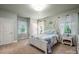 A serene bedroom features a white bed frame, soft blue accents, and bright natural light at 3301 Mcpherson St, Waxhaw, NC 28173