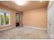 Neutral bedroom featuring a window view and door leading to a balcony at 3301 Mcpherson St, Waxhaw, NC 28173