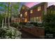Exterior view of a two story brick home with rear patio and landscaping at 3301 Mcpherson St, Waxhaw, NC 28173