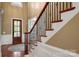Elegant foyer with hardwood floors and a staircase featuring decorative iron railings at 3301 Mcpherson St, Waxhaw, NC 28173