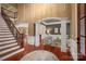 Spacious foyer with a staircase, hardwood floors, and an arched entryway leading to a cozy living room at 3301 Mcpherson St, Waxhaw, NC 28173