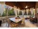 Covered outdoor patio featuring a large table, chairs, and a comfortable sofa at 3301 Mcpherson St, Waxhaw, NC 28173