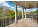 A covered porch with sturdy columns and black railing features a comfortable seating area for relaxation at 3301 Mcpherson St, Waxhaw, NC 28173