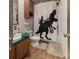 Fun bathroom with a dinosaur shower curtain, green counter, and neutral flooring at 3379 Appletree Ct, Vale, NC 28168
