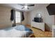 Bedroom featuring wood-look flooring, a ceiling fan, and a television at 3379 Appletree Ct, Vale, NC 28168